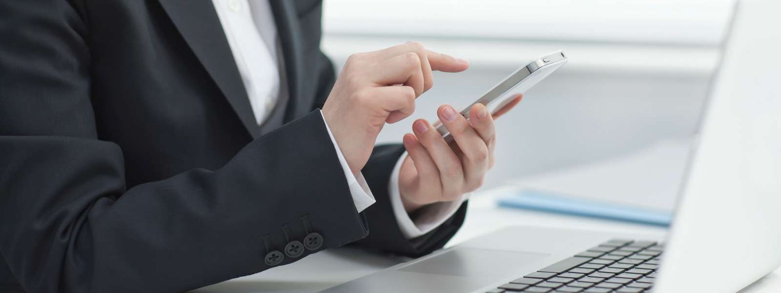 man in a suit holding a phone